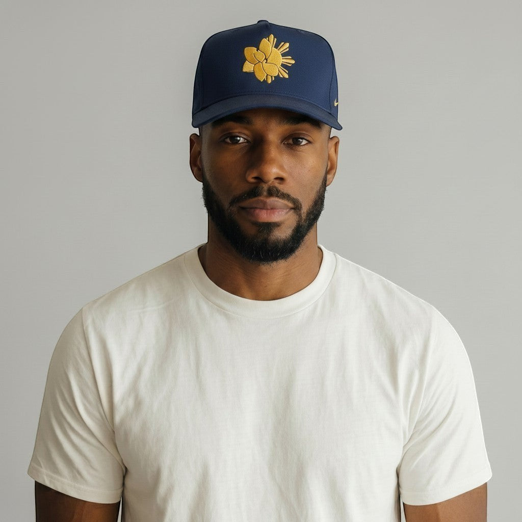 KA'EO Apparel Navy Embroidered Sampa-Sol Snapback with gold embroidery and adjustable snap closure.