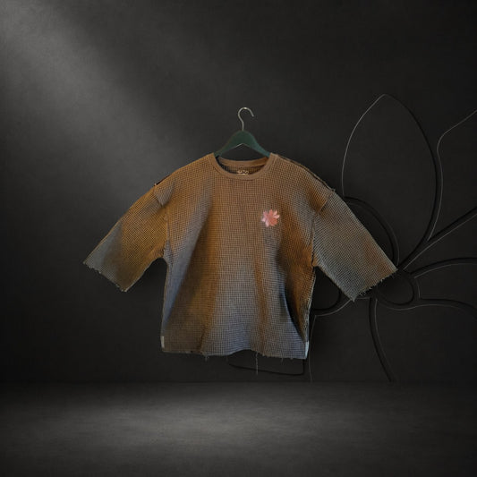 KA'EO Apparel brown cropped waffle knit top with raw hem edges and a delicate embroidered flower motif on the chest.