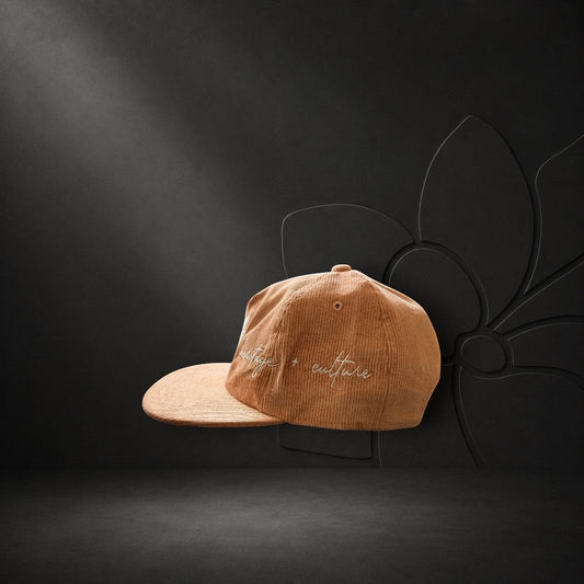 KA'EO Apparel vintage rose corduroy hat featuring delicate heritage + culture embroidery on a dark studio background.
