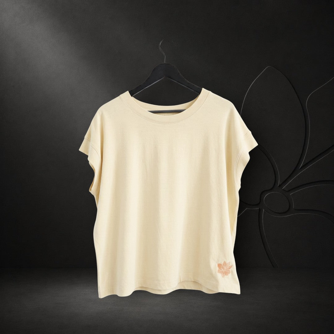 KA'EO Apparel vintage wash natural cotton t-shirt with short sleeves and small floral embroidery detail on the hem.