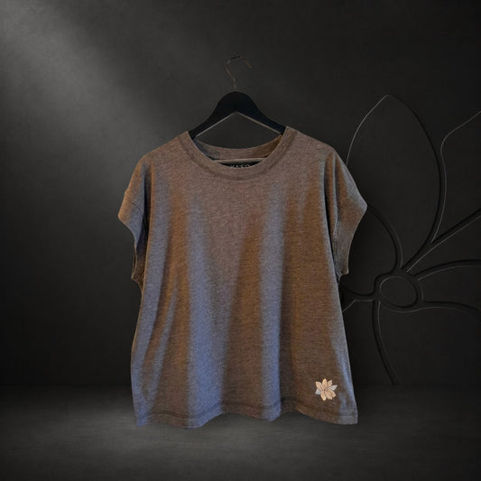KA'EO Apparel women's gray vintage wash t-shirt with a small white embroidered lotus flower detail on the hem.
