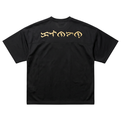 Back view of a black KA'EO Apparel cropped football jersey featuring cream-colored Baybayin script across the shoulders.