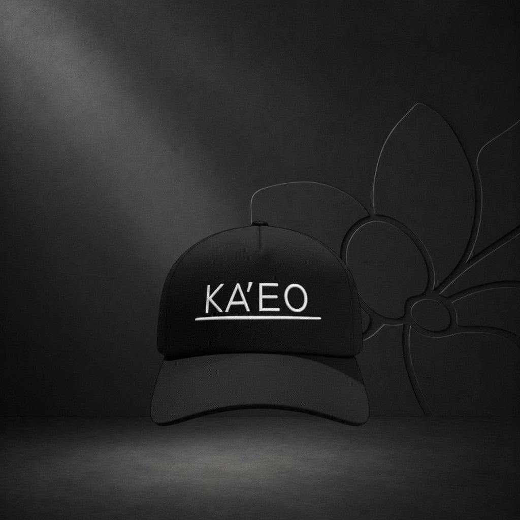 Black KA'EO Apparel snapback cap with white embroidered logo and underline detail. Structured brim, mid-profile fit.