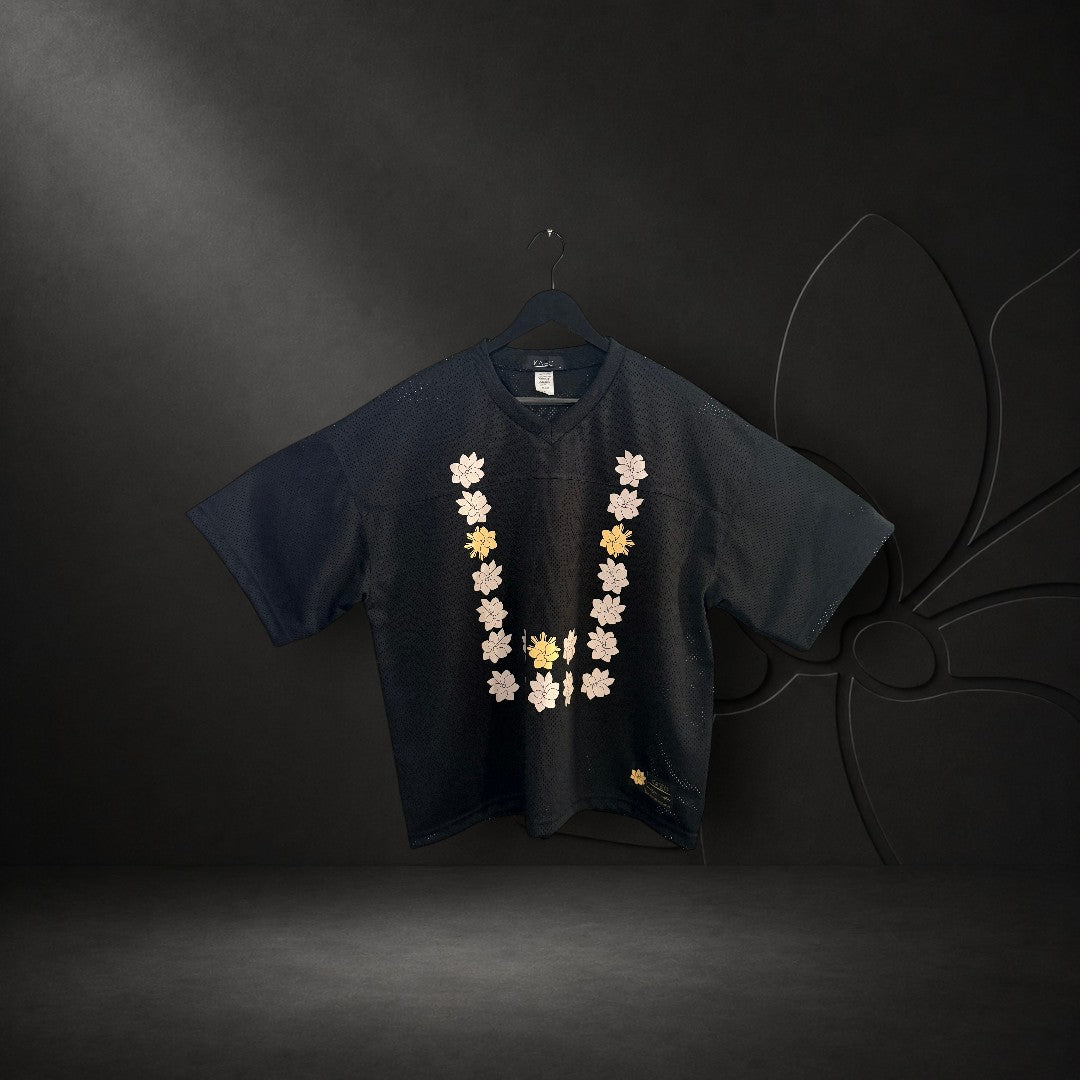 KA'EO Apparel black mesh cropped football jersey featuring a Sampaguita flower graphic in a Barong-style U-shape.