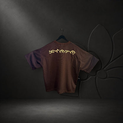 KA'EO Apparel brown mesh cropped football jersey with gold Baybayin script on the back hanging on a door