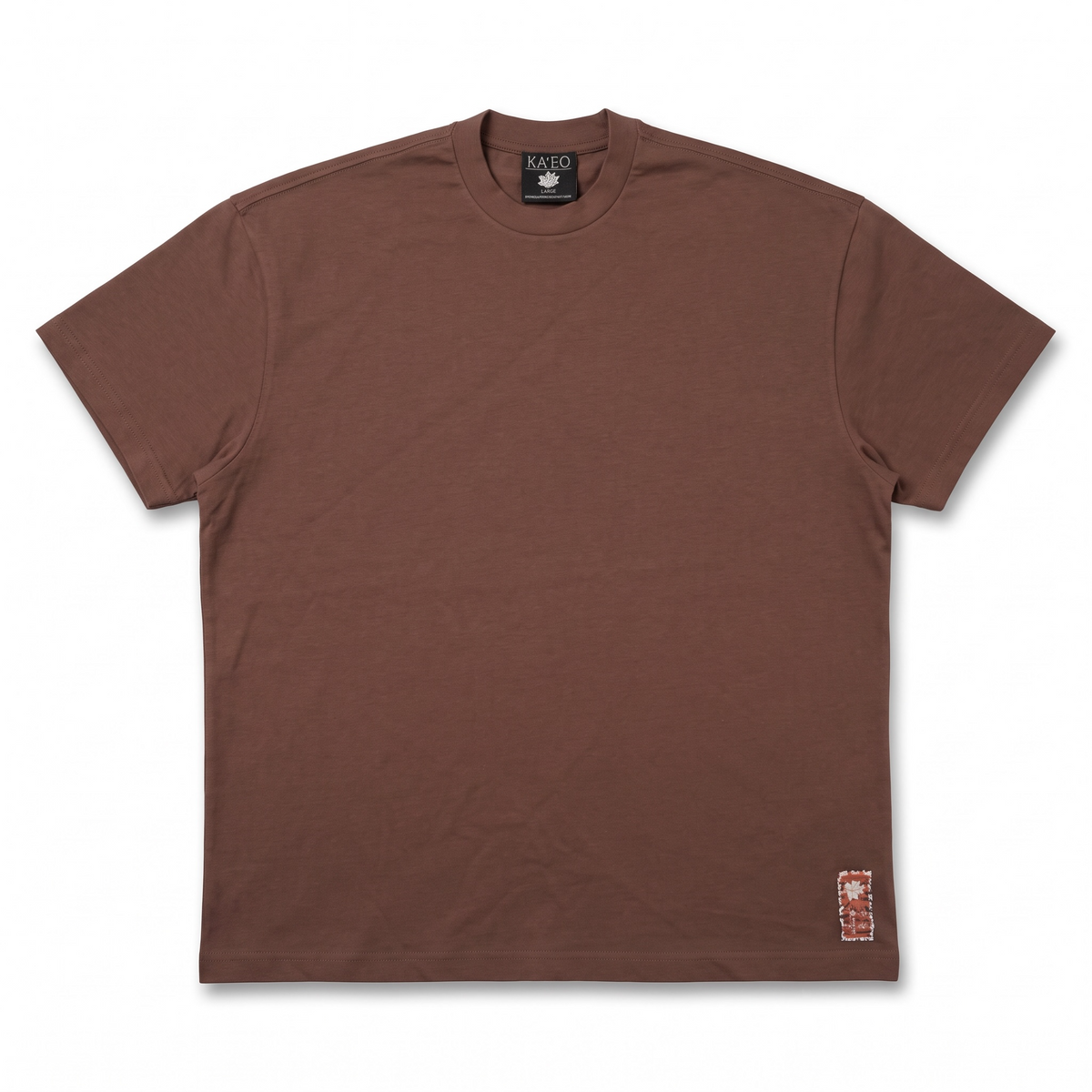 KA'EO Apparel brown cotton Sariah Goddess shirt with a small decorative patch accent near the hem