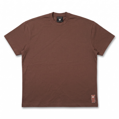 KA'EO Apparel brown cotton Sariah Goddess shirt with a small decorative patch accent near the hem