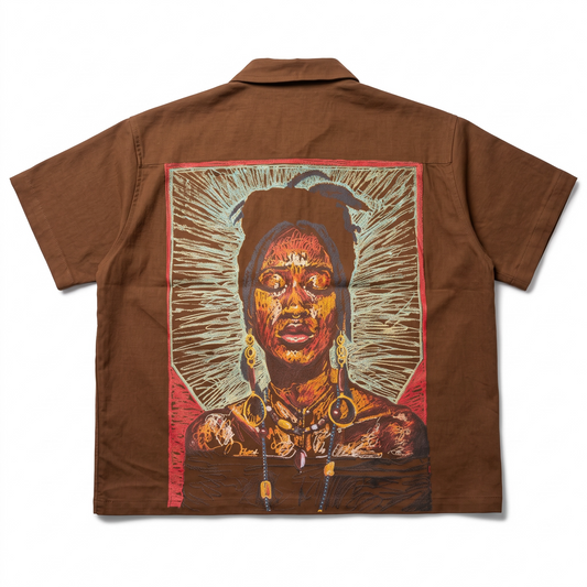KA'EO Apparel brown cotton short-sleeve button-up shirt featuring a vibrant artistic portrait graphic on the back.