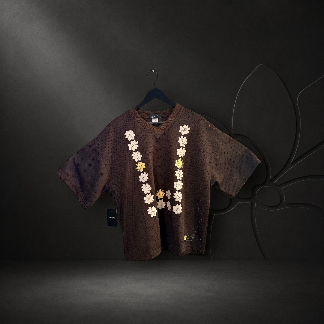 KA'EO Apparel brown mesh cropped football jersey with a U-shaped Sampaguita floral print on the front.