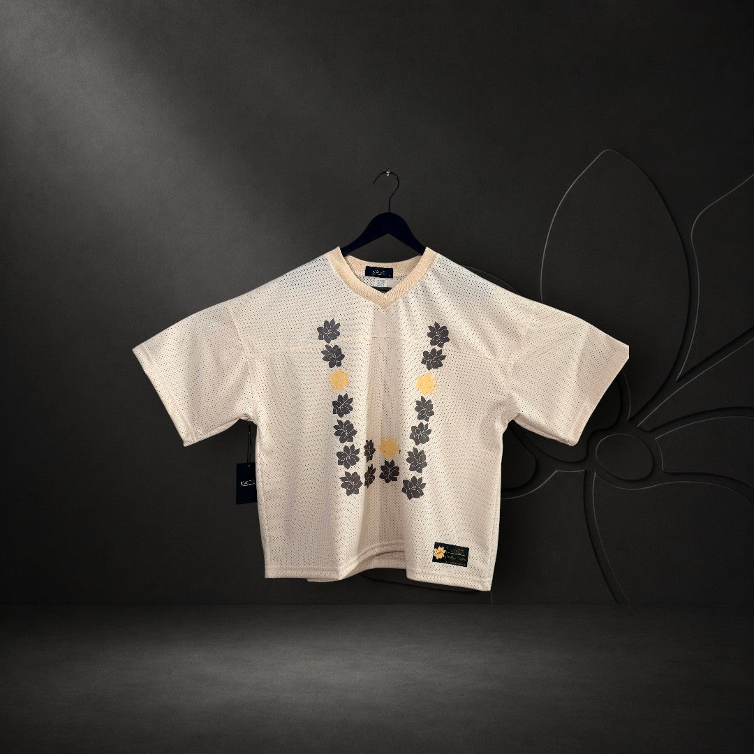 KA'EO Apparel cropped football jersey in cream mesh with a Sampaguita flower graphic in a U-shape Barong style print.