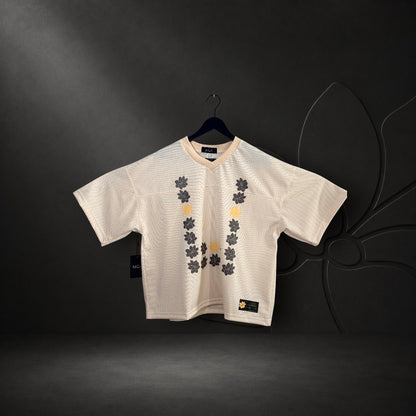 KA'EO Apparel cropped football jersey in cream mesh with a Sampaguita flower graphic in a U-shape Barong style print.