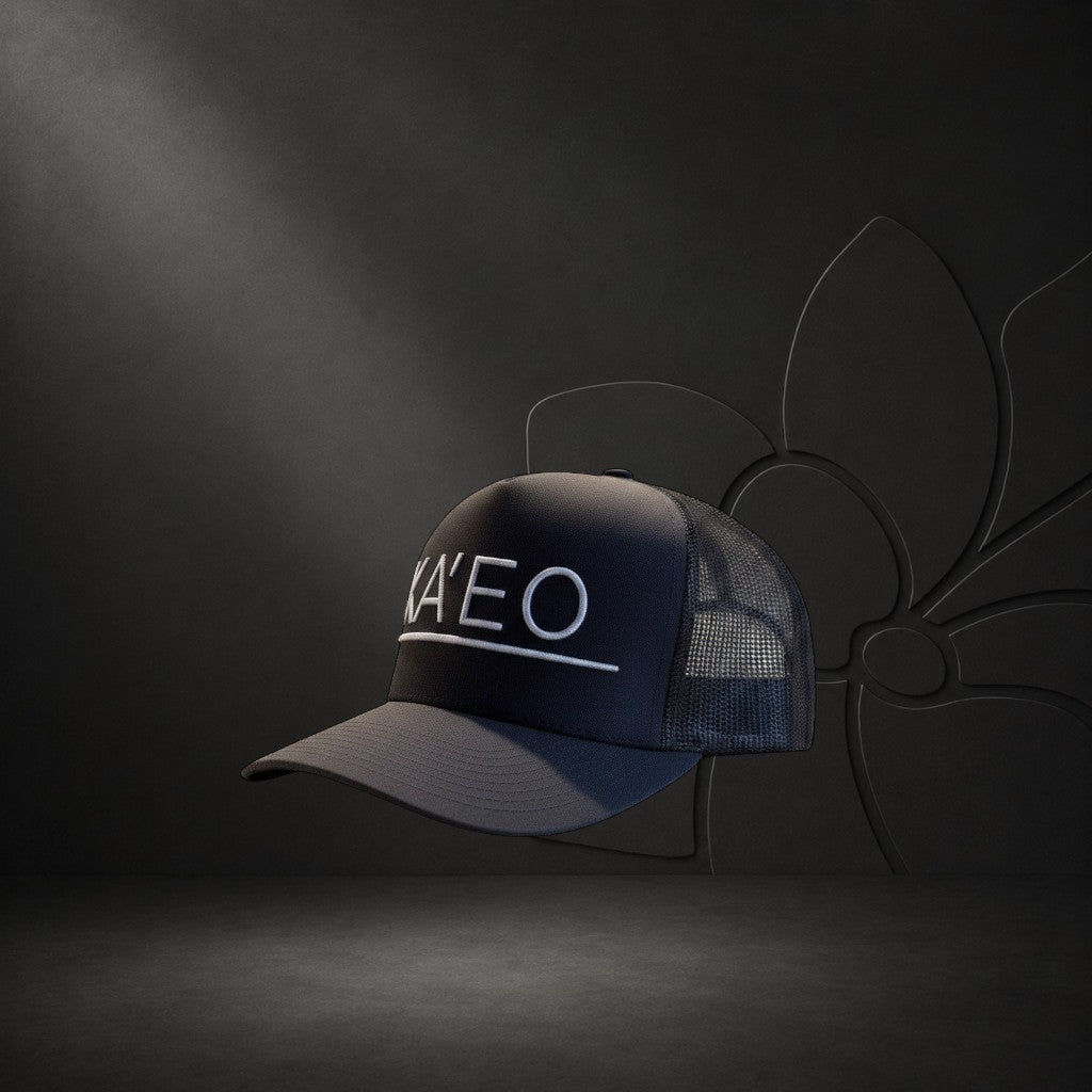 KA'EO Apparel dark grey trucker hat with white embroidered logo and mesh back panels.