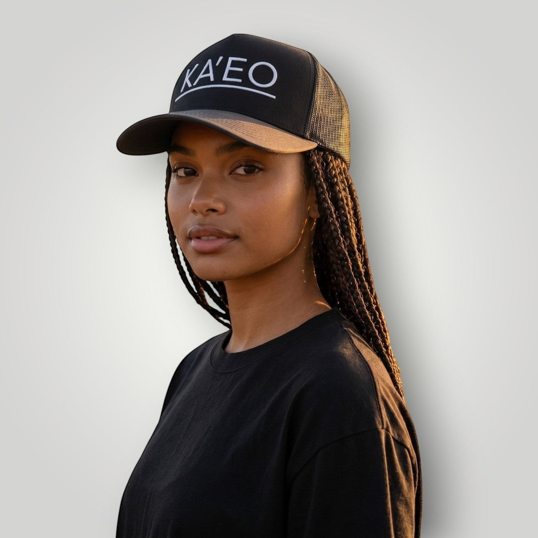 KA'EO Apparel dark grey trucker hat with white embroidered logo and mesh back