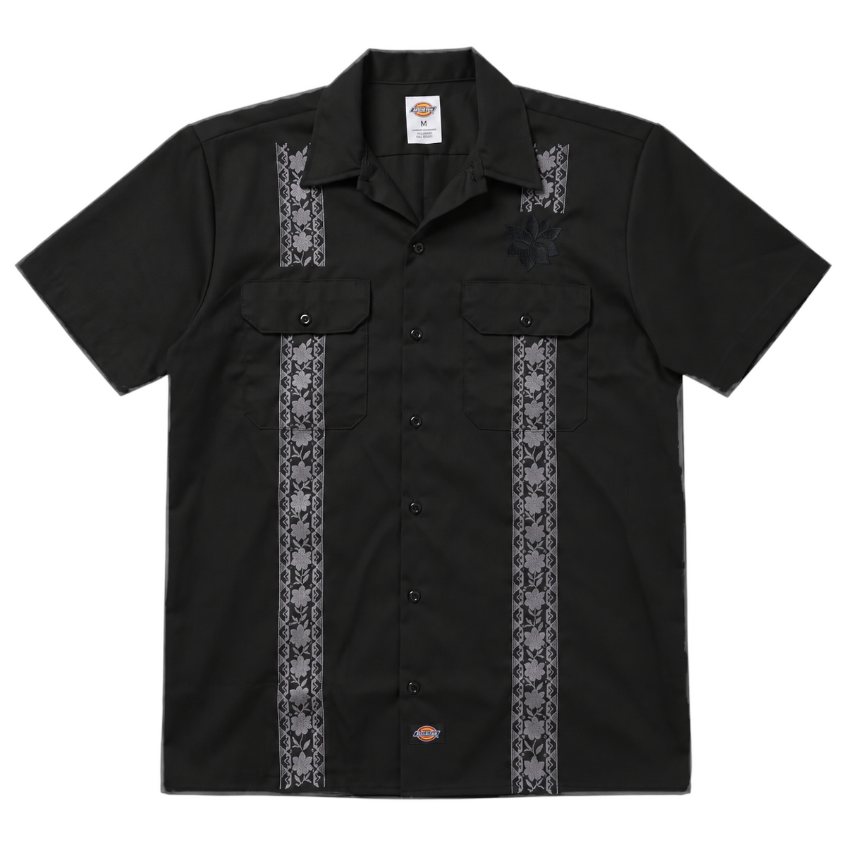 KA'EO Apparel x Dickies black short-sleeve guayabera shirt with vertical floral embroidery and dual chest pockets.