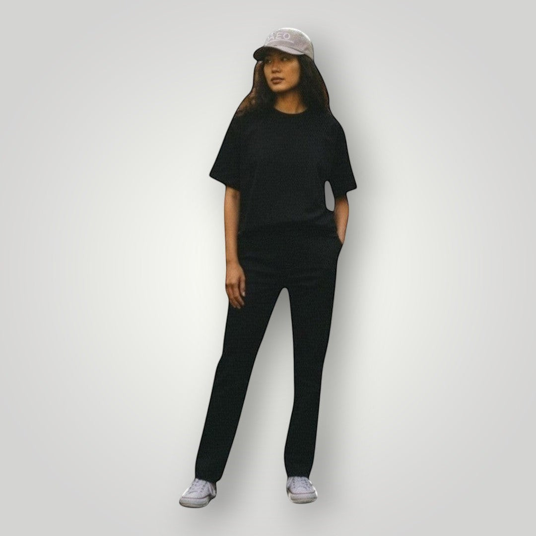 KA'EO Apparel gray embroidered snapback cap worn by a woman in a tropical forest setting.