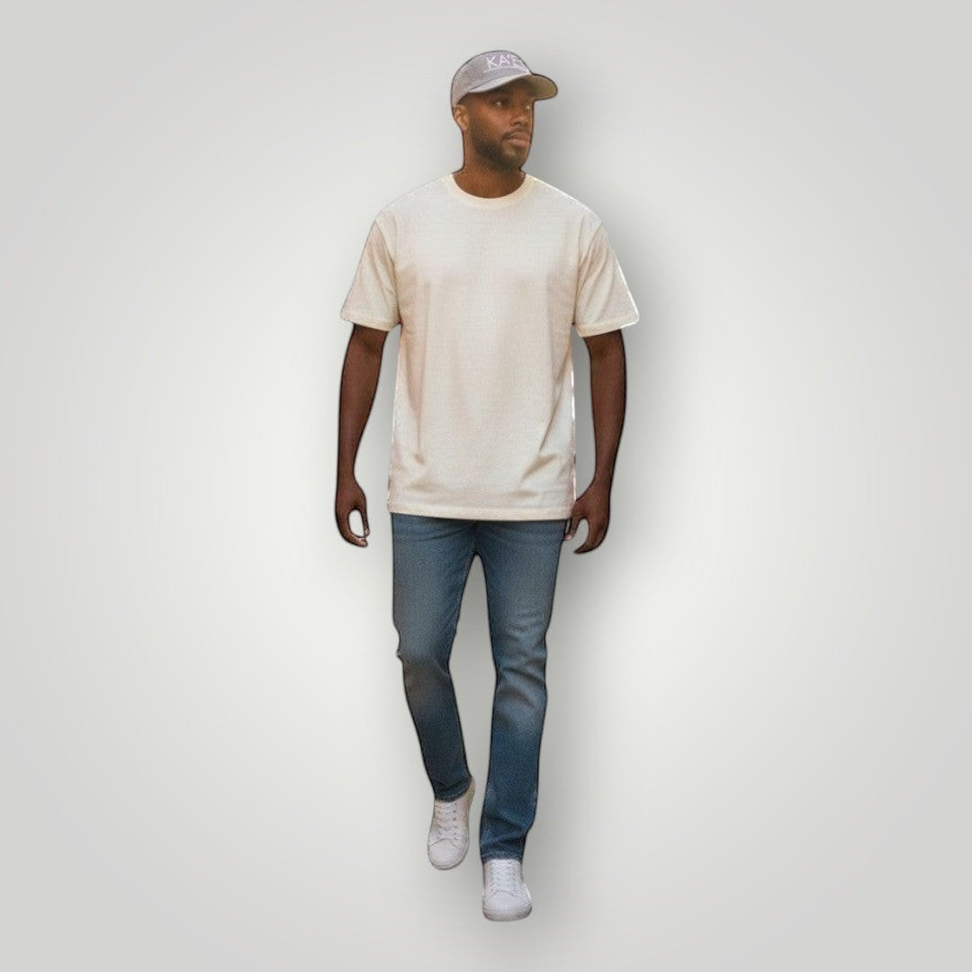 KA'EO Apparel gray embroidered snapback cap worn by a man walking on a cobblestone street.