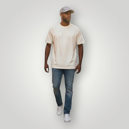 KA'EO Apparel gray embroidered snapback cap worn by a man walking on a cobblestone street.