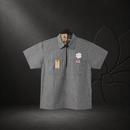 KA'EO Apparel grey pinstripe short-sleeve butcher shirt with quarter-zip, two chest pockets, and floral embroidery.