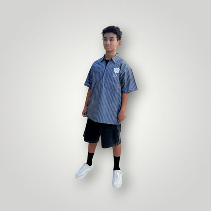 KA'EO Apparel grey pinstripe short-sleeve butcher shirt with quarter-zip and floral embroidery.