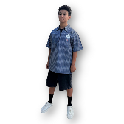 KA'EO Apparel x Ben Davis grey pinstripe short-sleeve quarter-zip shirt with sampaguita embroidery on a model