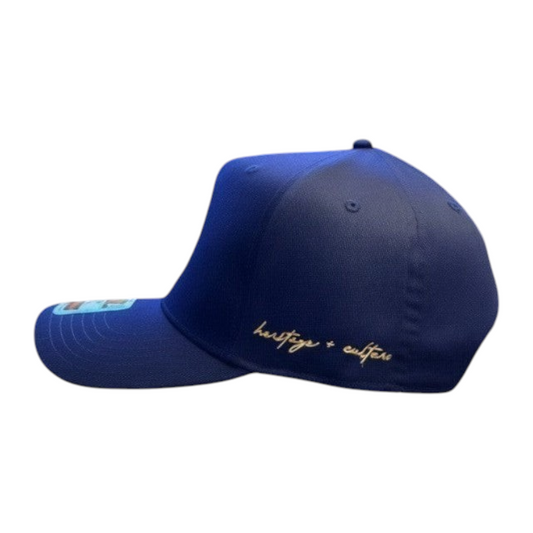 KA'EO Apparel Navy Embroidered Sampa-Sol Snapback with gold "heritage + culture" script on side.
