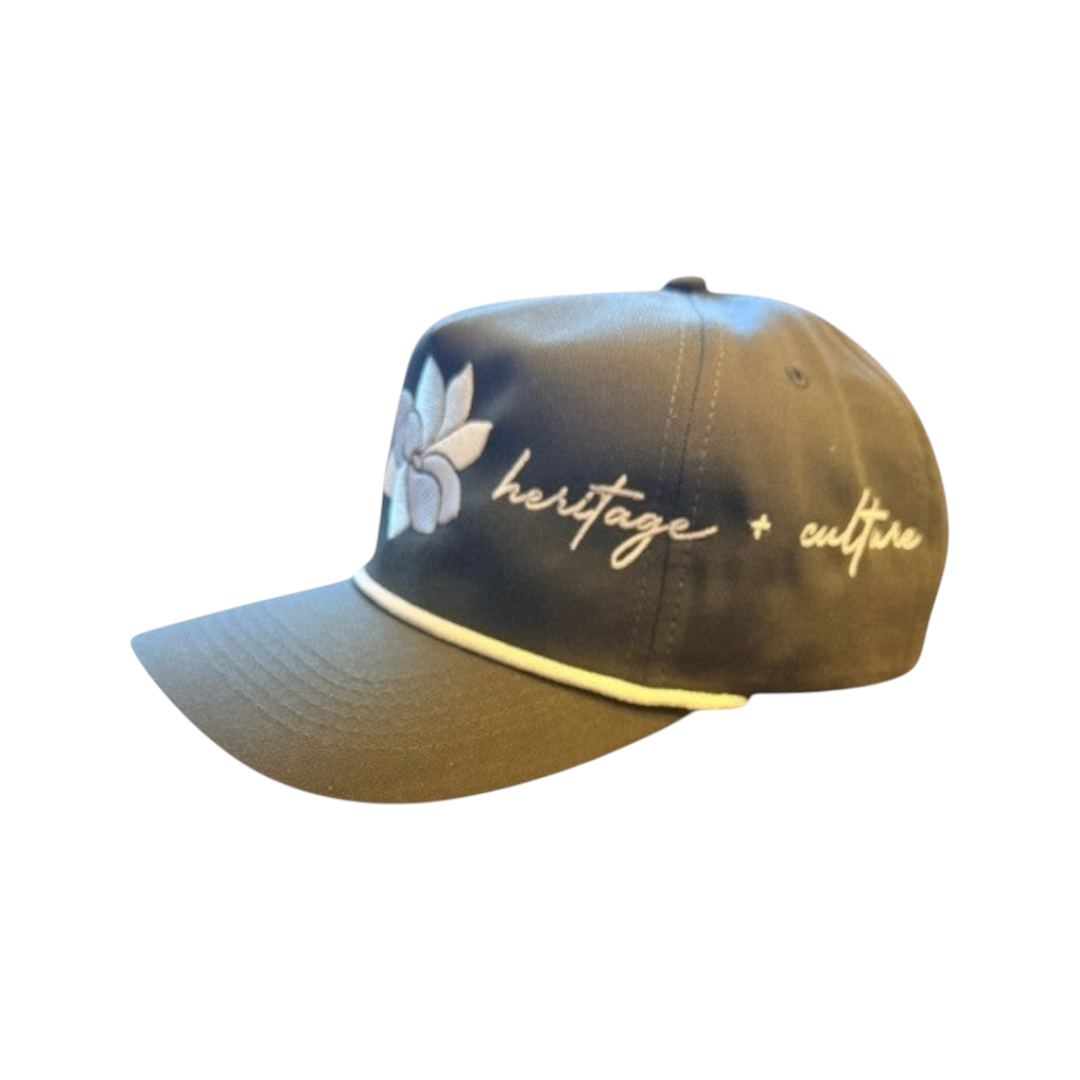 KA'EO Apparel olive green baseball cap with white embroidered Sampaguita flower and "heritage + culture" text.