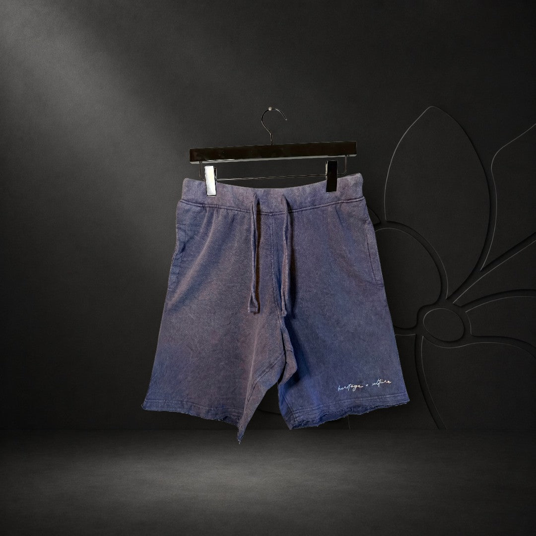 KA'EO Apparel heather blue vintage wash distressed shorts with drawstring waist and raw hem detail.