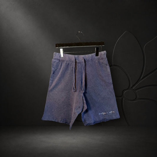 KA'EO Apparel heather blue vintage wash distressed shorts with drawstring waist and raw hem detail.